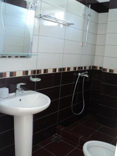 a bathroom with a sink and a shower at Vila Kosteli in Himare
