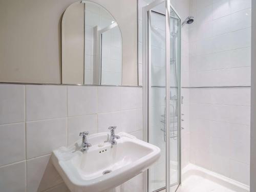 a white bathroom with a sink and a shower at 3 Bed in Hawkshead Village LLH21 in Hawkshead