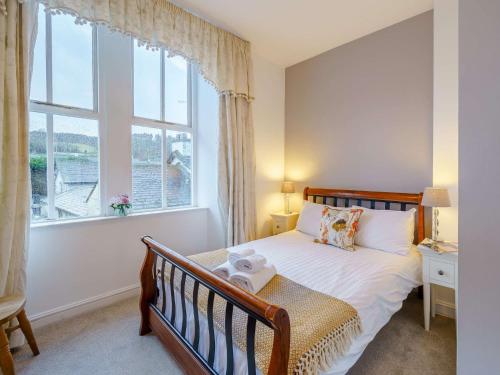 a bedroom with a bed and a large window at 3 Bed in Hawkshead Village LLH21 in Hawkshead