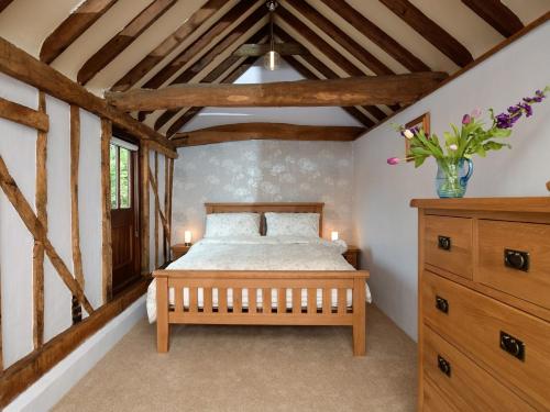 a bedroom with a bed in a room with wooden ceilings at 1 Bed in Thaxted 51222 in Thaxted