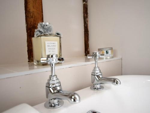 a bathroom with two faucets on a sink at 1 Bed in Thaxted 51222 in Thaxted