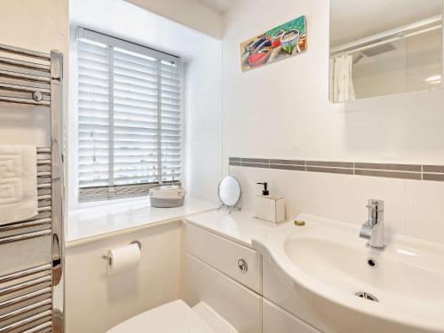 a white bathroom with a sink and a toilet at 3 Bed in Hawkshead Village LLH39 in Hawkshead