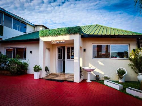 a house with a red brick driveway in front of it at Altos del Iguazu in Puerto Iguazú