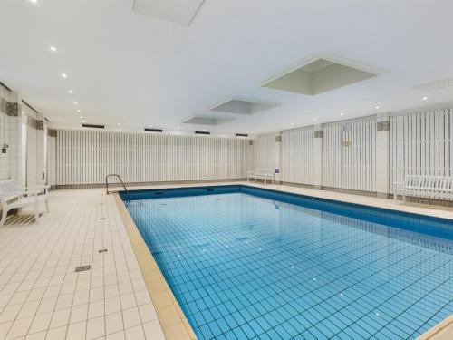 a large swimming pool in a building at Oland Whg 23 Küstensegler in Wyk auf Föhr