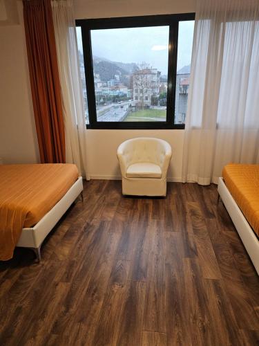 a hotel room with two beds and a window at Victoria Royal Garden in Como