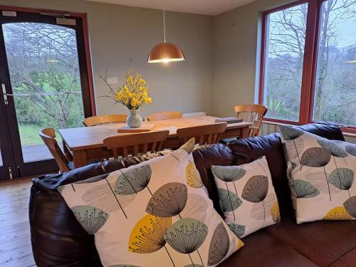 a living room with a couch and a dining table at Helnoweth Lodge in Penzance