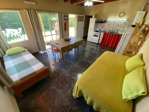 Un dormitorio con una cama y una cocina con una mesa. en Complejo "NONI" 200 mts del mar, barrio tranquilo, en Las Grutas