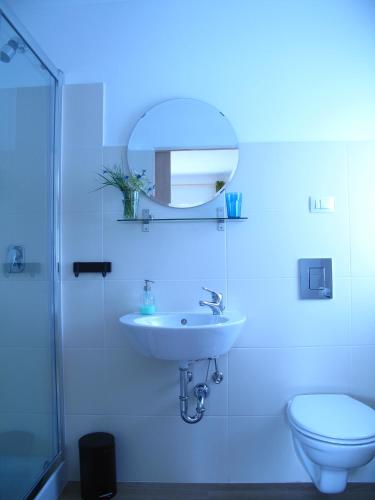 a white bathroom with a sink and a toilet at Guesthouse Bor Plitvice Lakes in Plitvička Jezera
