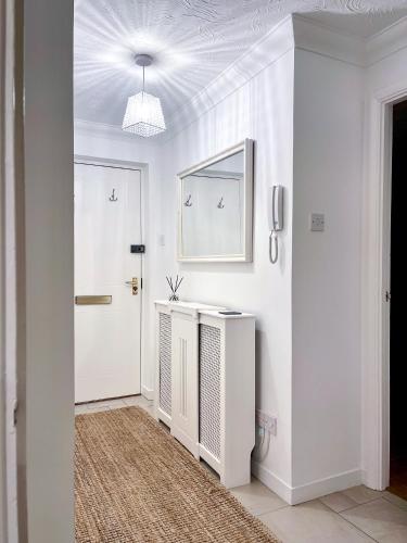 a white hallway with a white door and a white wall at Immaculate 2-Bed Apartment in Rochester in Rochester