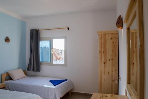 a bedroom with two beds and a window at Al Deira Dahab Hotel in Dahab