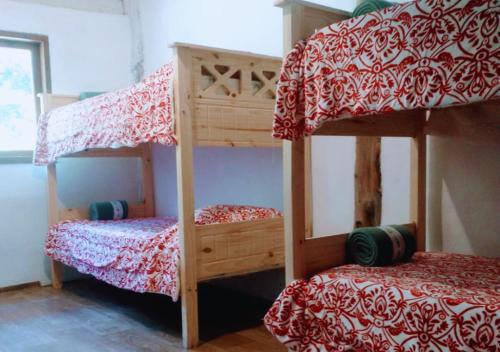 two bunk beds in a small room with at Adobe Ecohostel in Villa Meliquina