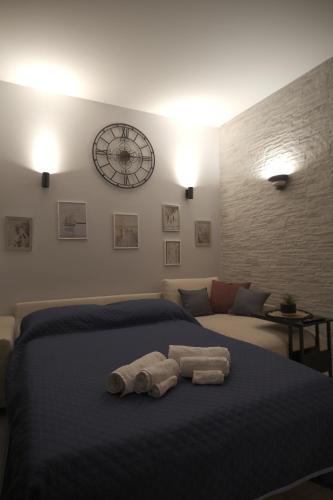 a bedroom with a bed with two towels on it at OdeMar Apartment in Pozzuoli