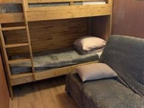 two bunk beds with pillows and a bed in a room at Appartement Vars, 1 pièce, 6 personnes - FR-1-330B-29 in Vars