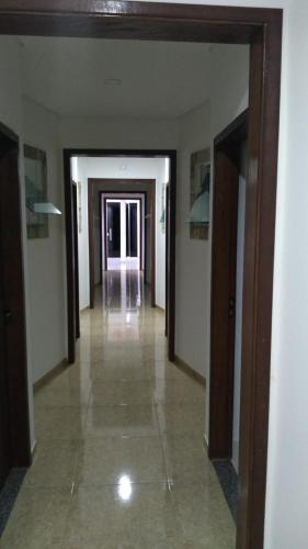 an empty hallway in a building with doors and a hallwayngth at Sitio Virtual Net in Lambari