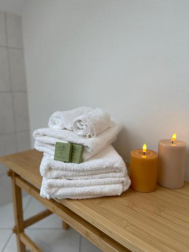 a pile of towels and a candle on a table at Ferienwohnung Huimelig im Allgäu in Röthenbach