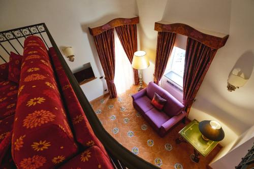 an overhead view of a bedroom with a bed and a chair at Hotel Botanico San Lazzaro in Maiori