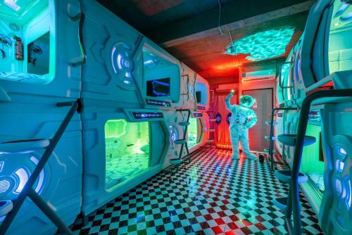 a person standing in a room in a train at Space Station Hostel in Ban Don Muang