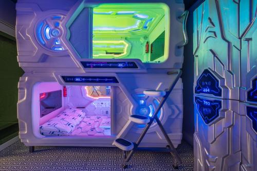 a play room with a laptop on a desk at Space Station Hostel in Ban Don Muang