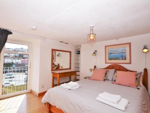 a bedroom with a large bed and a window at 2 Bed in Brixham BX026 in Brixham
