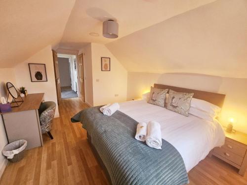 a bedroom with a bed with white towels on it at Tigh Na Sith in Connel