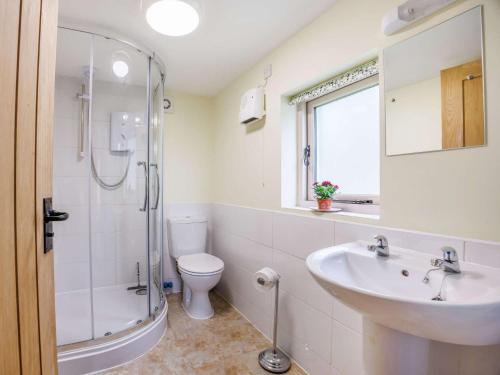 a bathroom with a sink and a toilet and a shower at 1 Bed in Devizes 54779 in Seend