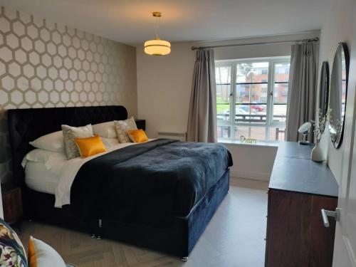 a bedroom with a large bed and a window at Farnborough central in Farnborough