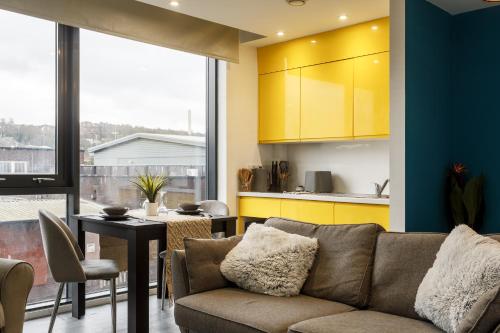 a living room with a couch and a table at Cozy Studio Apartment in Sheffield in Sheffield