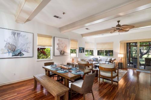 a living room with a table and chairs and a couch at Mauna Lani Fairways 302 in Waikoloa