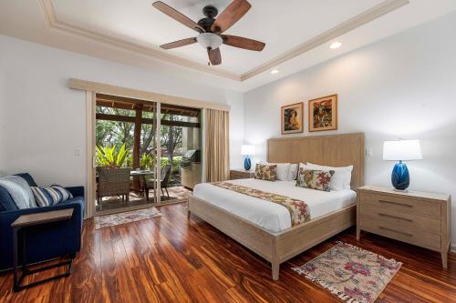 a bedroom with a bed and a ceiling fan at Mauna Lani Fairways 302 in Waikoloa