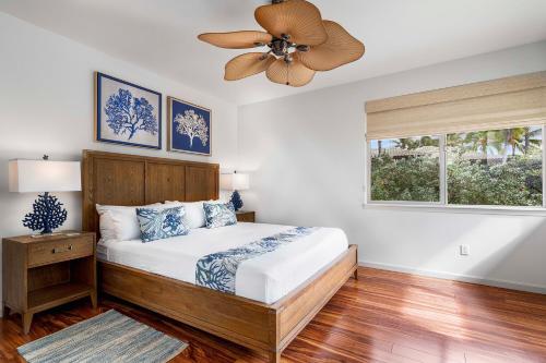 a bedroom with a bed with a ceiling fan at Mauna Lani Fairways 302 in Waikoloa
