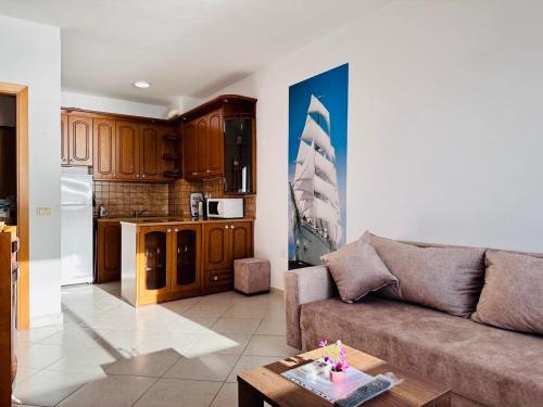 a living room with a couch and a kitchen at Renata Seaview Apartment 310 in Durrës