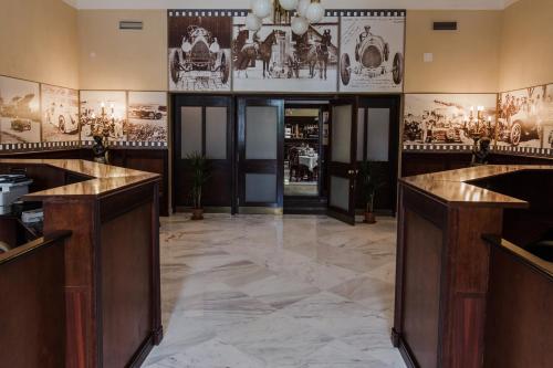 a lobby with marble flooring and wooden counter tops at Palace Inn in Jíloviště