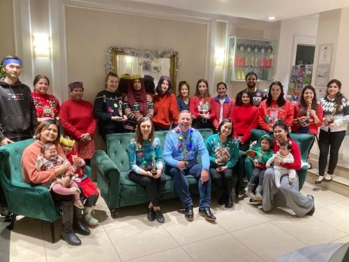 a group of people posing for a picture in a room at Astor Court Hotel in London
