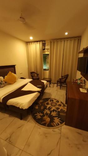 a hotel room with a bed and a table and a room at Hotel Velvet Horizon in Chandīgarh