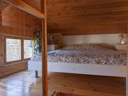 a bedroom with a bed in a wooden cabin at The Bean Barn in Arçais