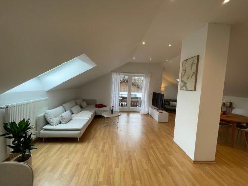 a living room with a couch and a table at Ferienwohnung Huimelig im Allgäu in Röthenbach