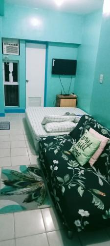 a bedroom with a bed with black and white sheets at Cityland Jane's Apartment in Tagaytay