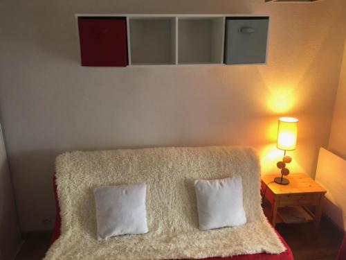 1 dormitorio con 1 cama con 2 almohadas y lámpara en L'enclaves, en Les Contamines-Montjoie