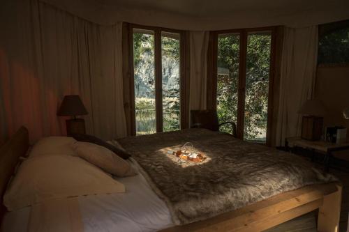 ein Schlafzimmer mit einem Bett und einem Kamin darauf in der Unterkunft Prehistoric Lodge in Vallon-Pont-dʼArc