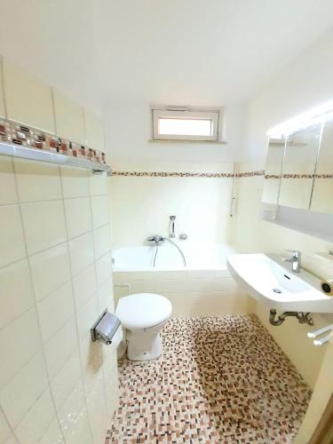 a bathroom with a toilet and a sink at City Apartment Starnberg in Starnberg
