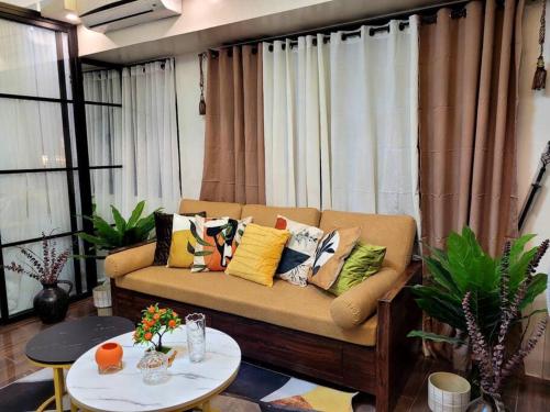 a living room with a couch with pillows on it at Lady Di Suite in Makati in Manila
