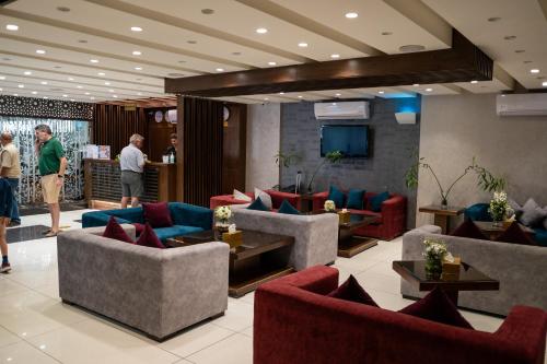 a lobby with couches and a television and people at My Hotel by Trend in Aqaba