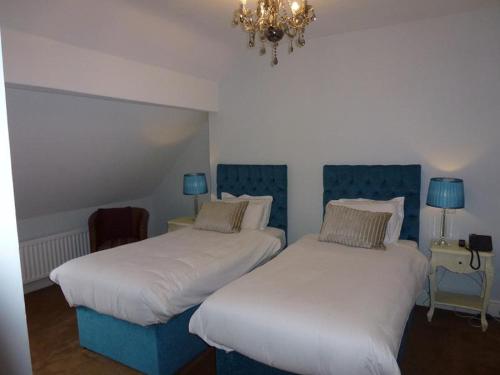 two beds sitting next to each other in a room at The Oak Kelsall in Kelsall