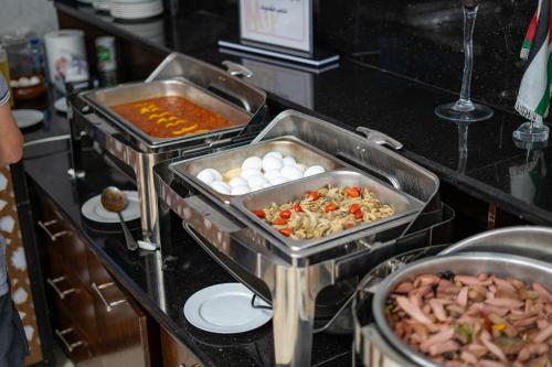 two trays of food on a kitchen counter at My Hotel by Trend in Aqaba