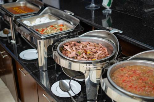 a kitchen with three pots of food on a counter at My Hotel by Trend in Aqaba