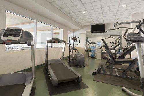 a gym with treadmills and ellipticals in a room at Country Inn & Suites by Radisson, Calgary-Northeast in Calgary