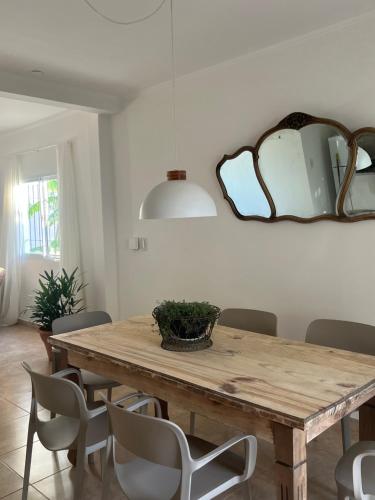 a dining room table with chairs and a mirror at Duplex del Río in Concordia
