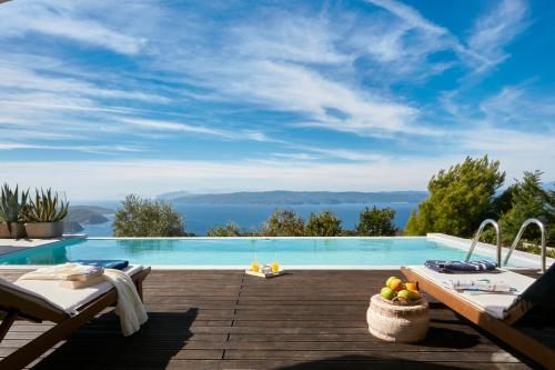 a swimming pool with a view of the water at Luxury Villa in Kechria 2 in Kechria