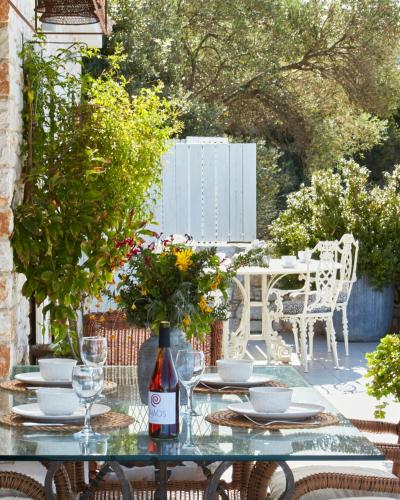 a table with glasses and a bottle of wine at Luxury Villa in Kechria 2 in Kechria