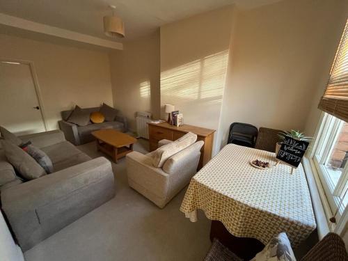 una sala de estar con un sofá y una mesa en Two bed flat in popular York Rd, en Birmingham